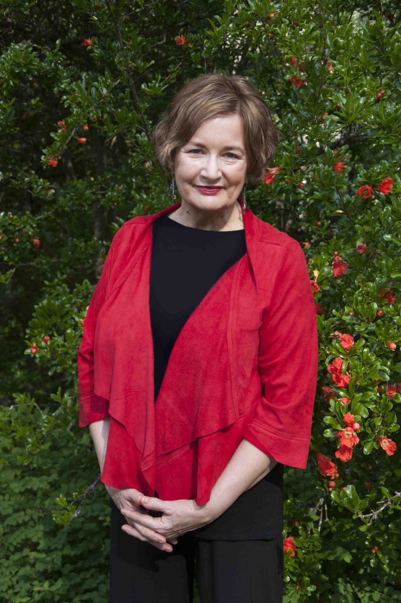 Jackie French in front of greenery