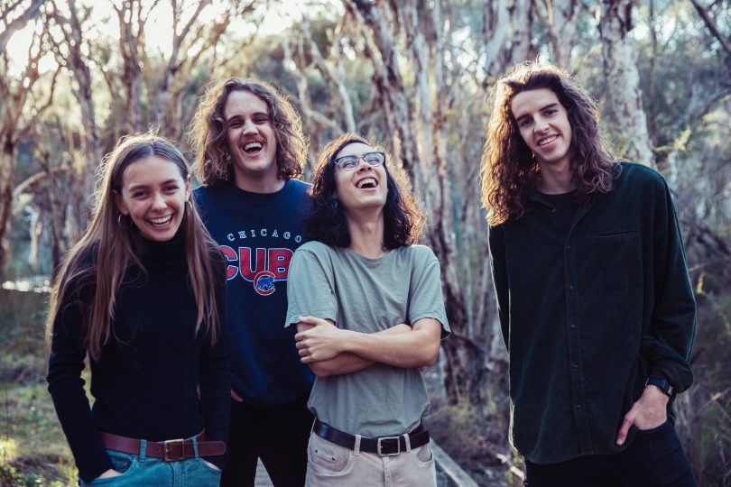 Photograph of the four members of Spacey Jane laughing in the bush