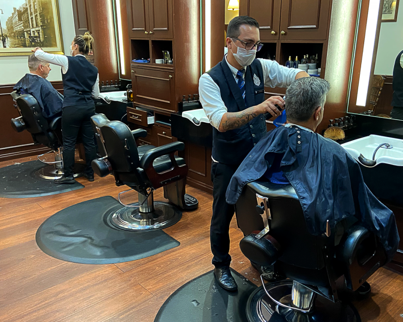 Barbers take additional precautions to prevent the spread of the COVID-19 virus during their work at Truefitt and Hill in Civic.
