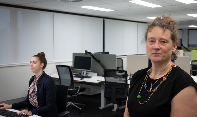 Dr Kerryn Coleman (right) in office with colleague behind desk.