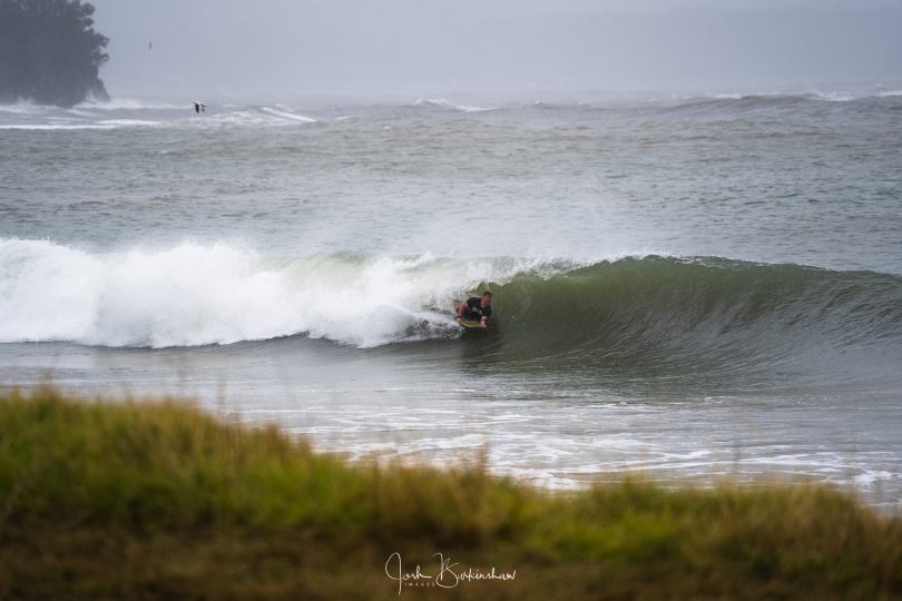 A surfer getting barrelled at Casey's Beach at Batehaven.