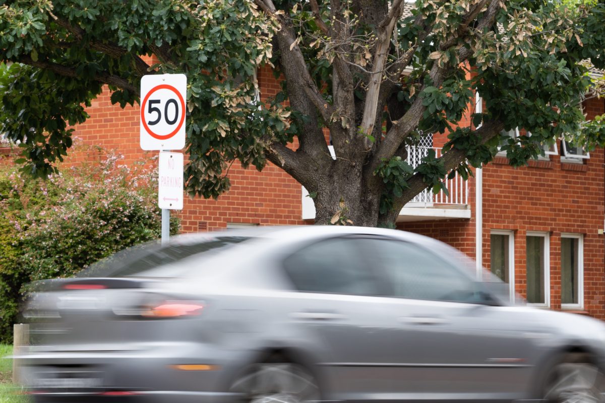 Car blurred as it passes a 50km/h zone in Canberra.