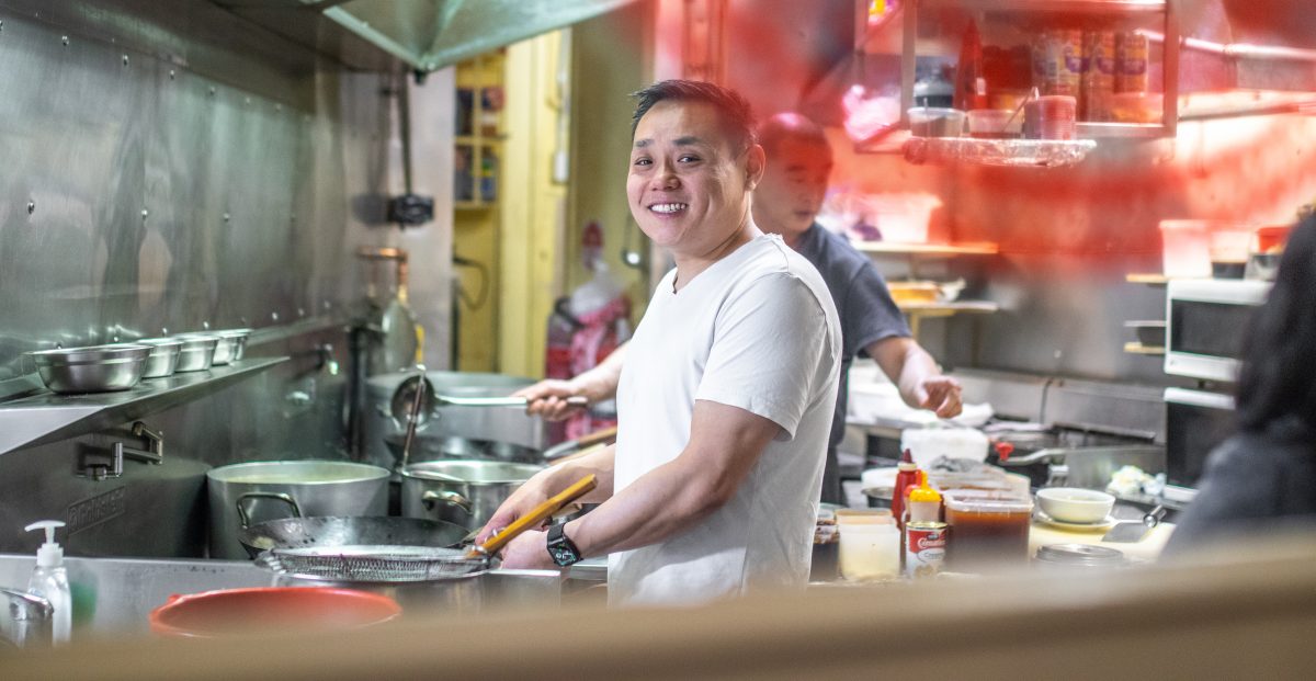 Man stir frying in a kitchen