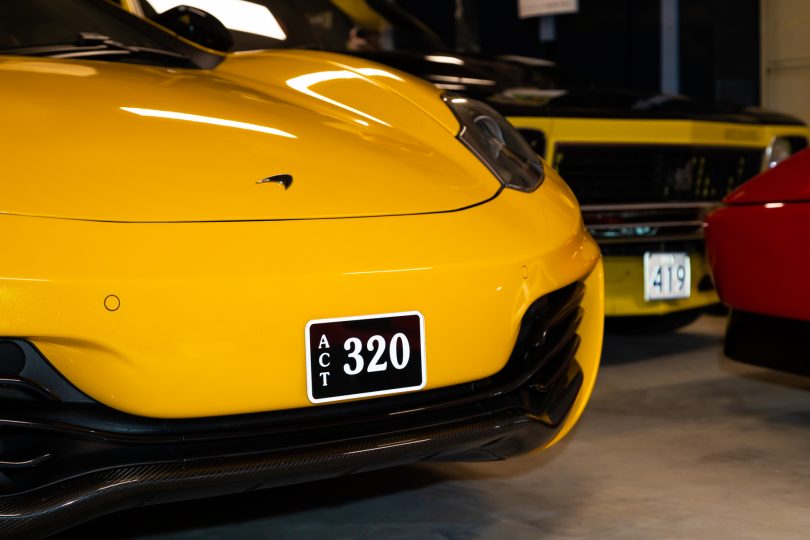 '320' ACT number plate on yellow car