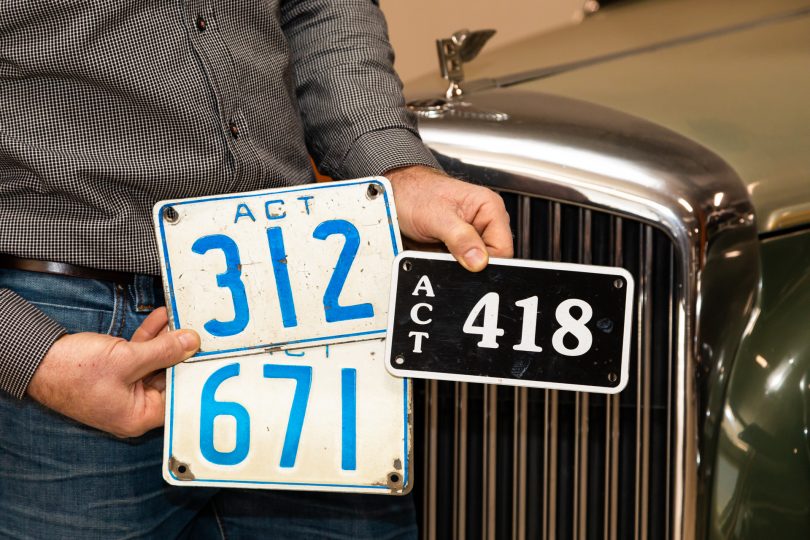 Darrell Leemhuis holding three ACT three-digit number plates
