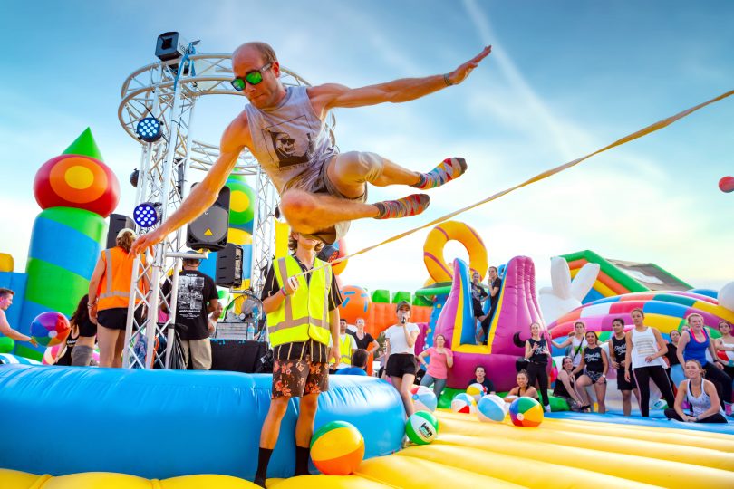 Man bouncing on inflatable castle