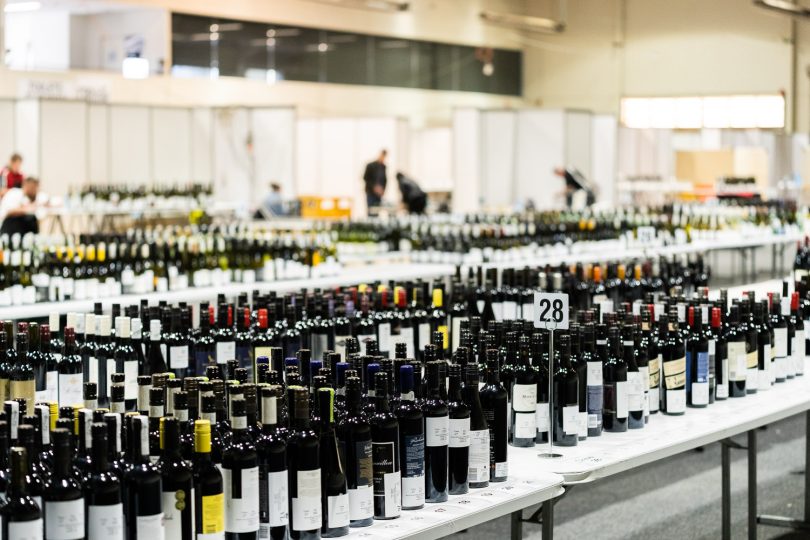 Hundreds of bottles of wines on trestle tables
