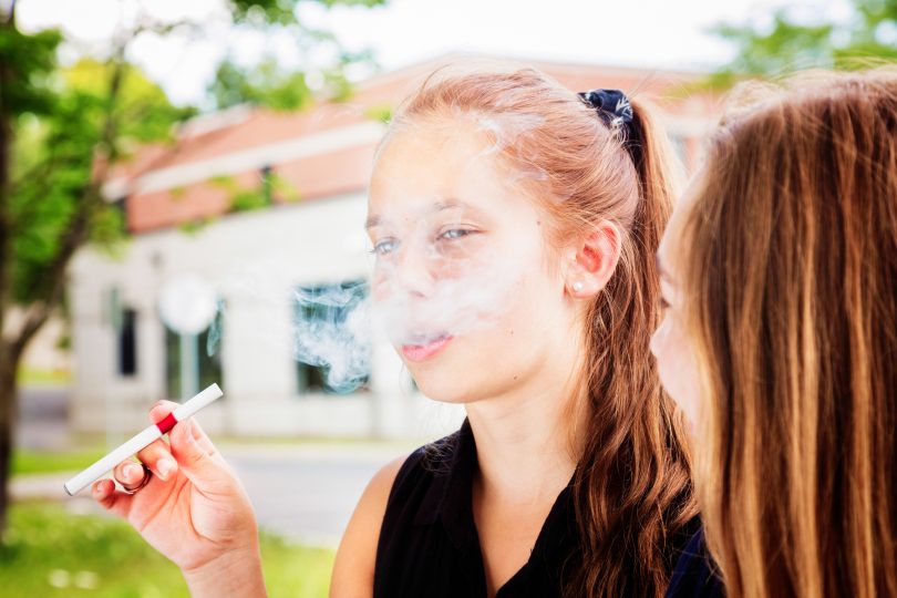 Youth smoking an e-cigarette