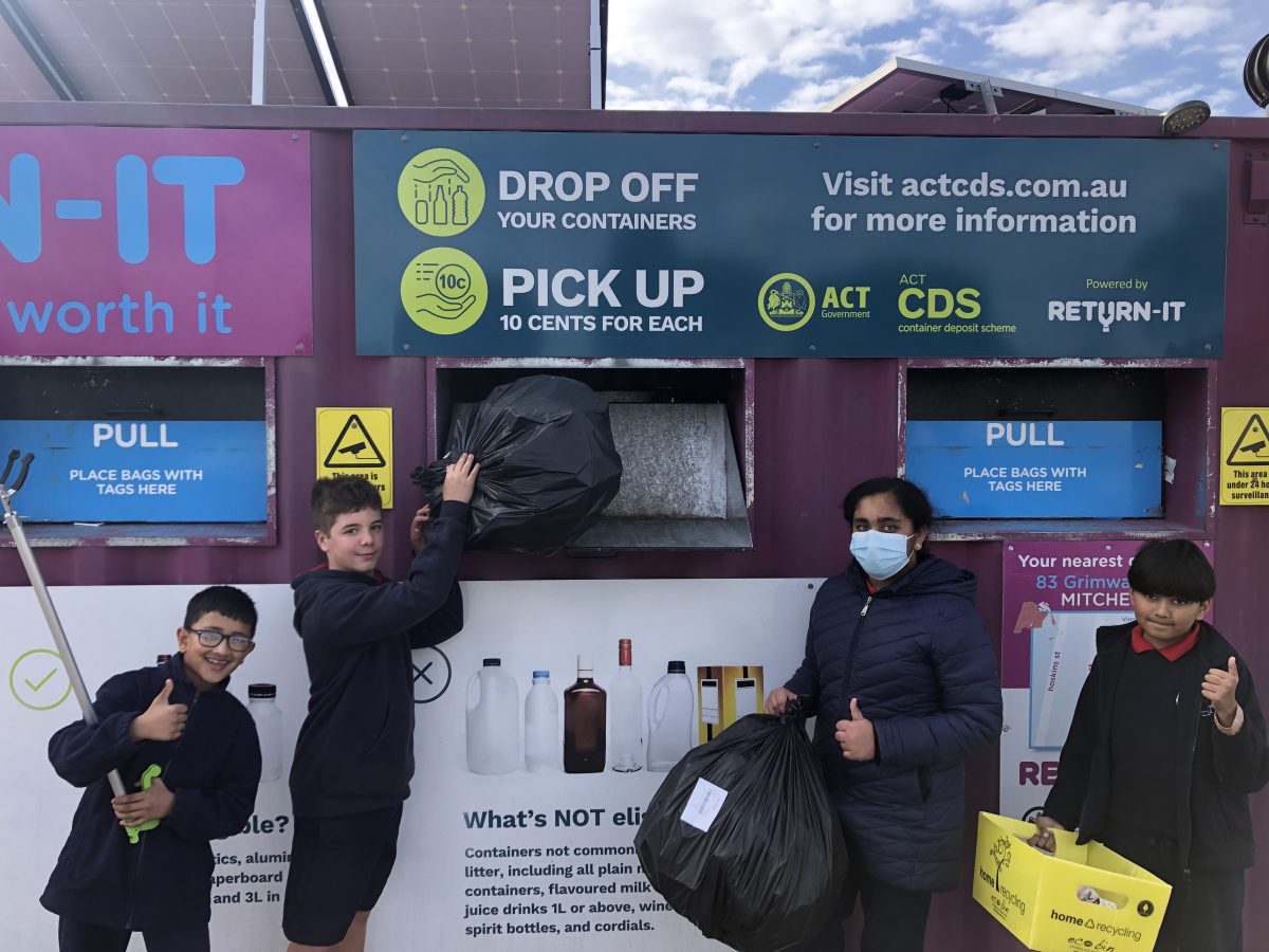 school students in front of a recycling centre