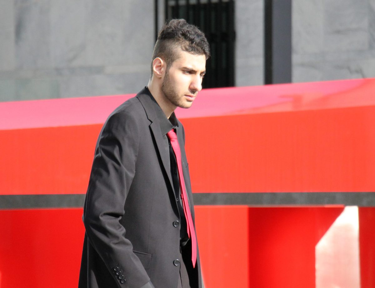 Man in black suit leaving court