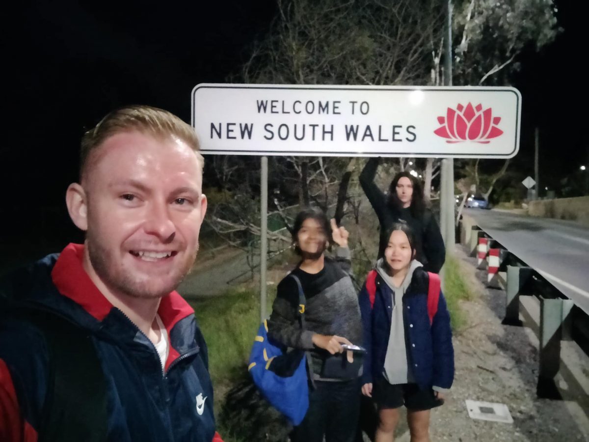 People at the NSW border sign