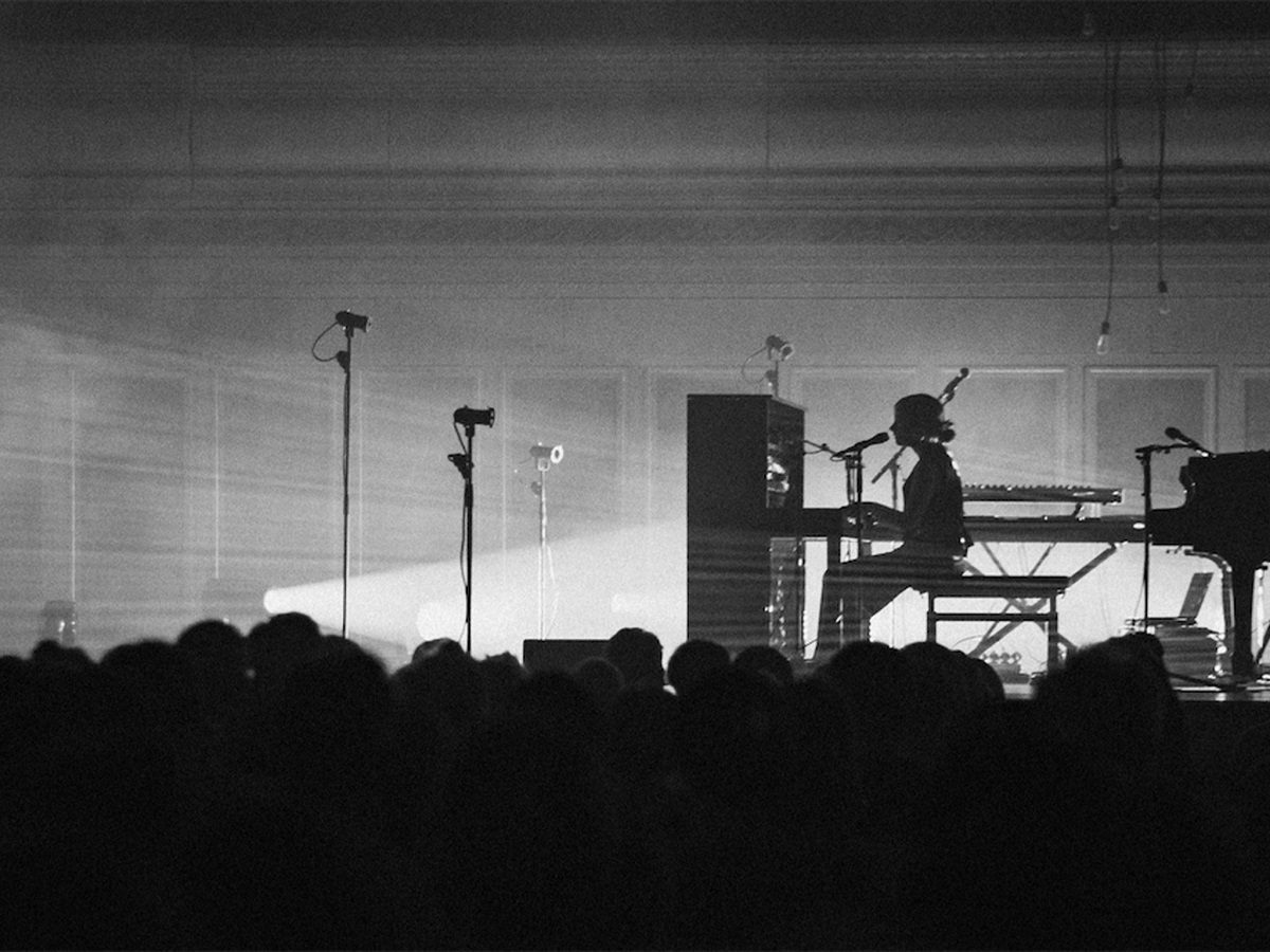 woman in silhouette playing the piano