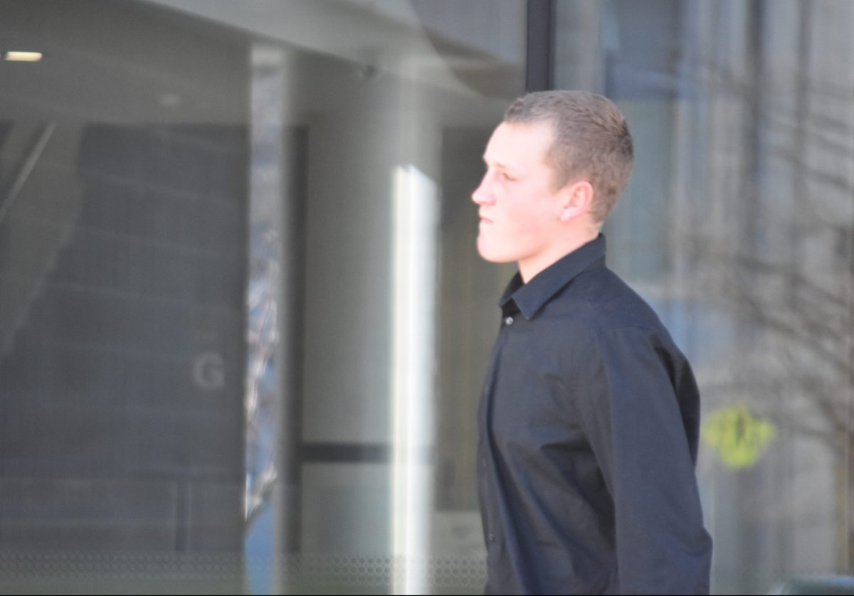 man in black shirt outside court
