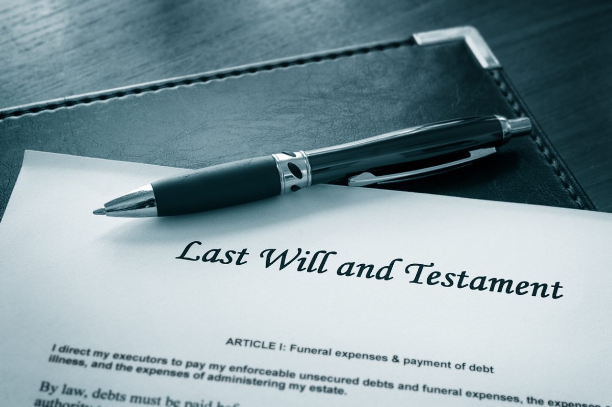 A pen resting on a the top of a document that reads Last Will and Testament