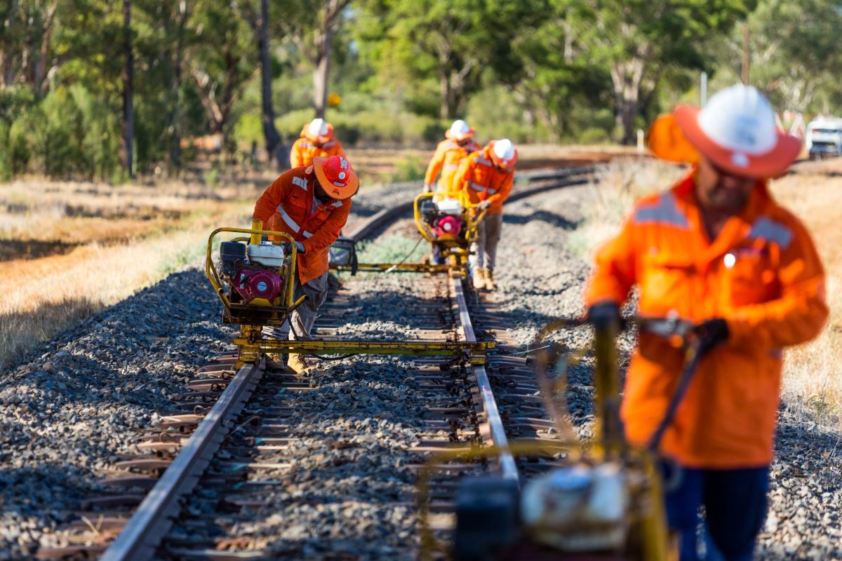 Workers in high-vis uniforms working on railway