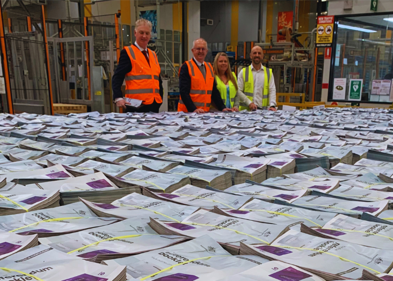 four people standing by referendum pamphlets
