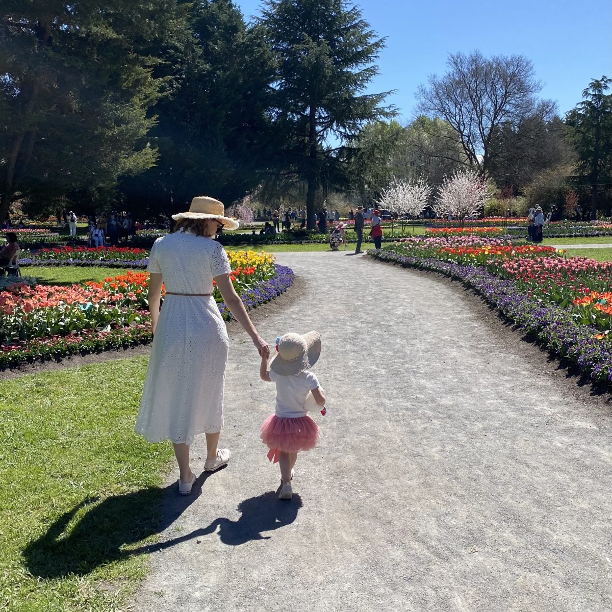mother and daughter walking in gardens