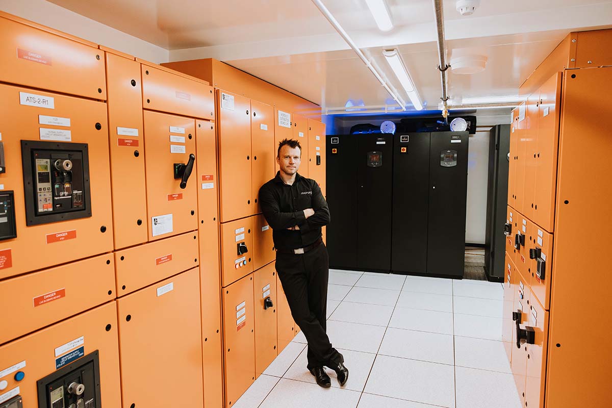 James Braunegg stands among lockers at Micron21 data centre