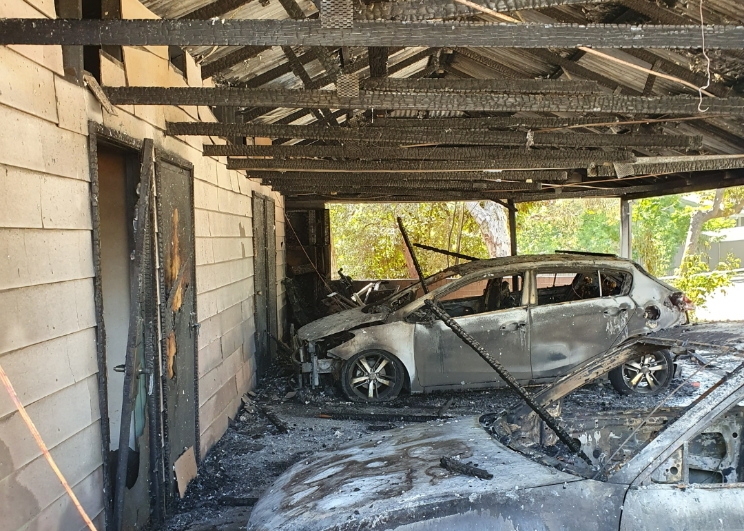house and cars damaged by fire