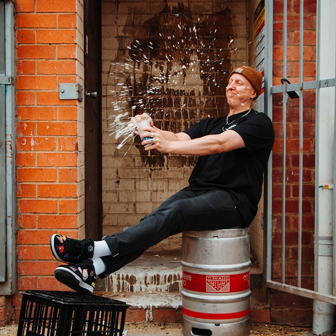 man cracking open a beer