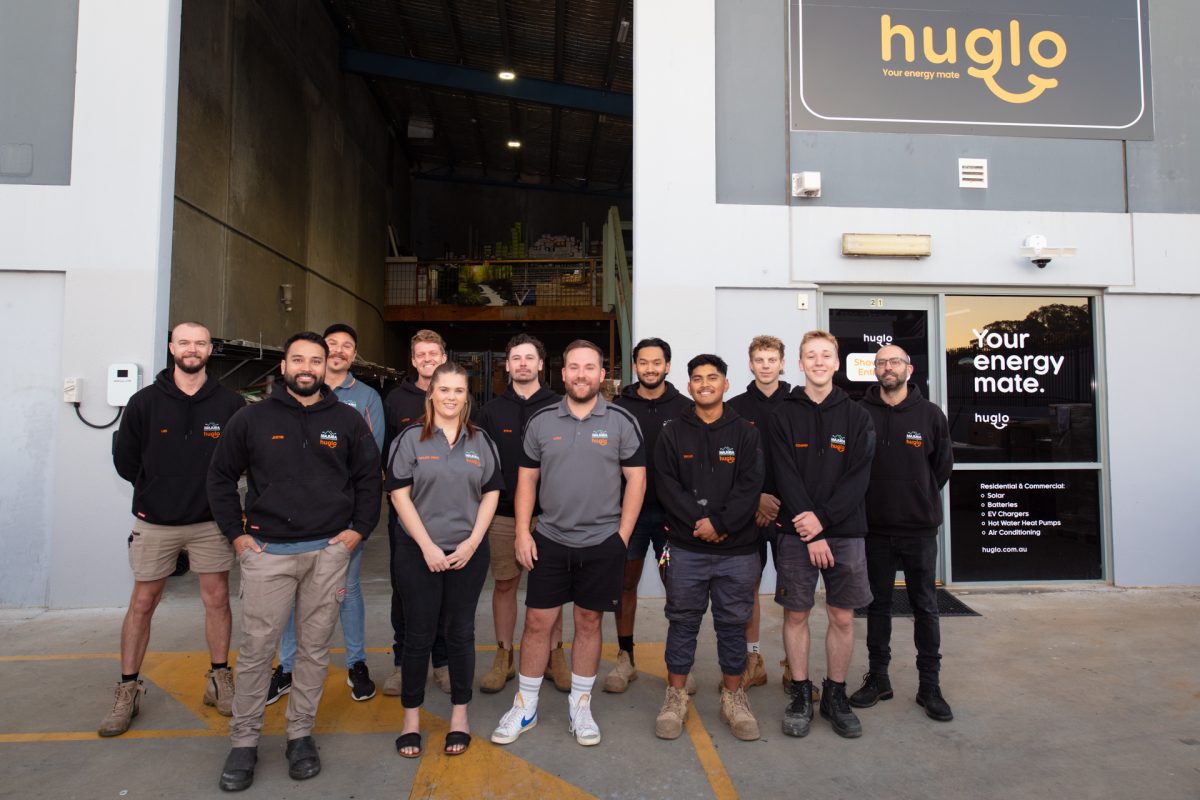 Huglo team in front of warehouse