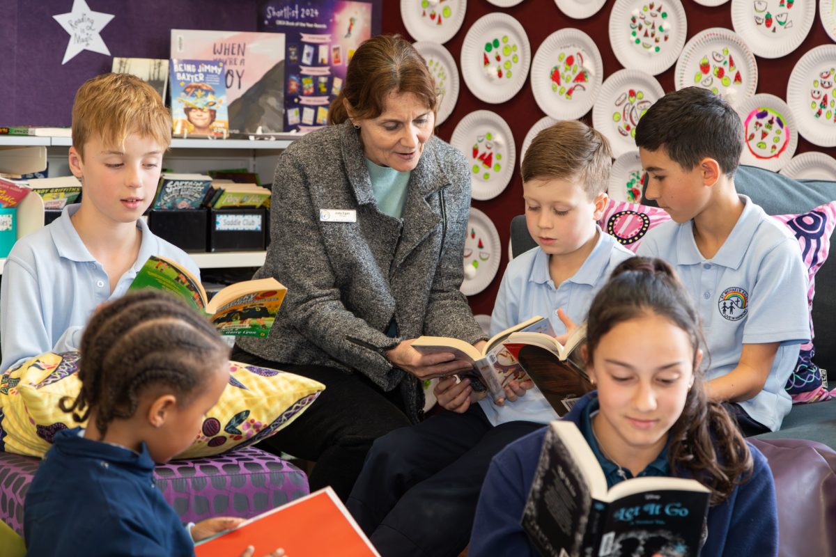 Teacher reading to male students