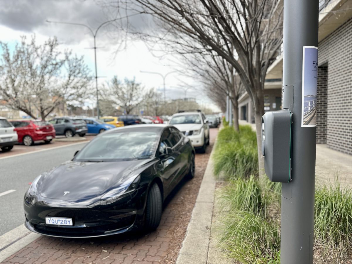 Tesla next to a lamppost