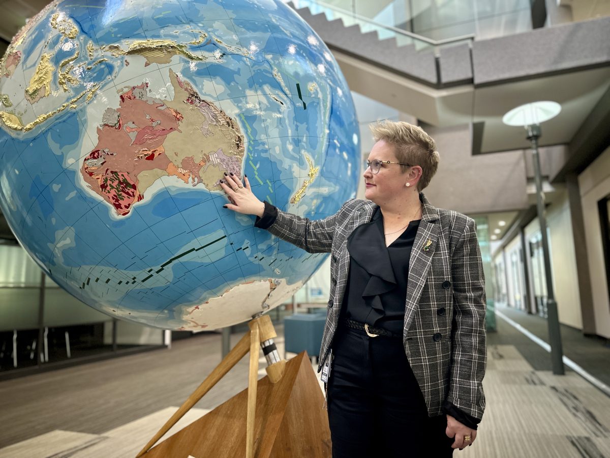 Lady pointing at globe