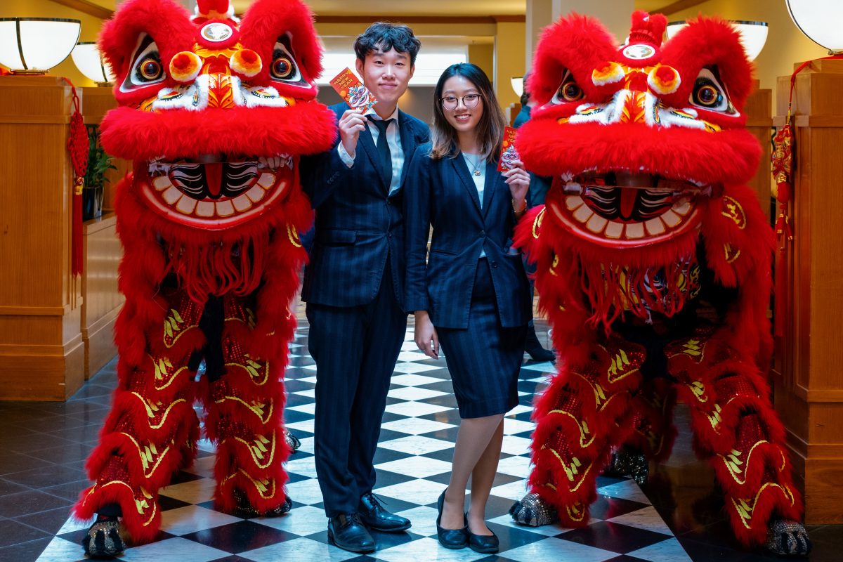 two people with Chinese lion dancers