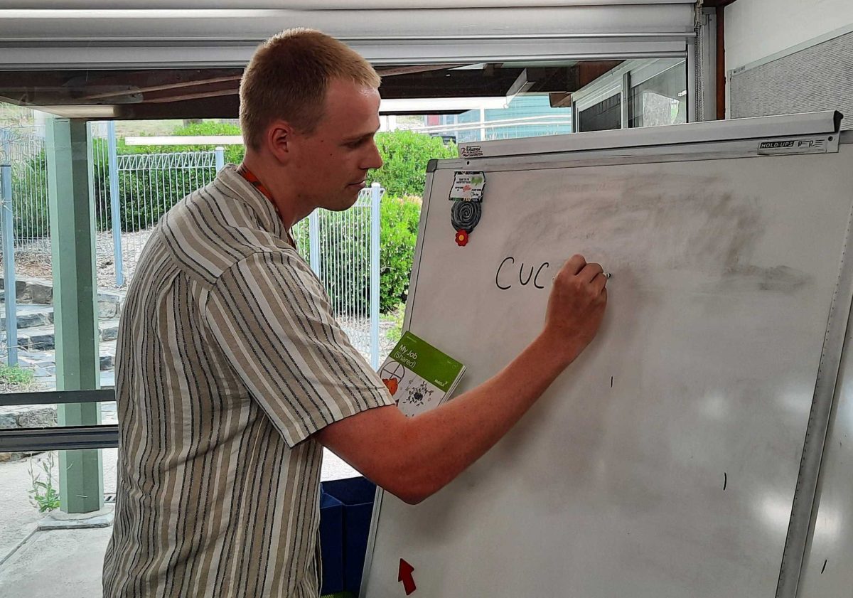 a man writing on a whiteboard