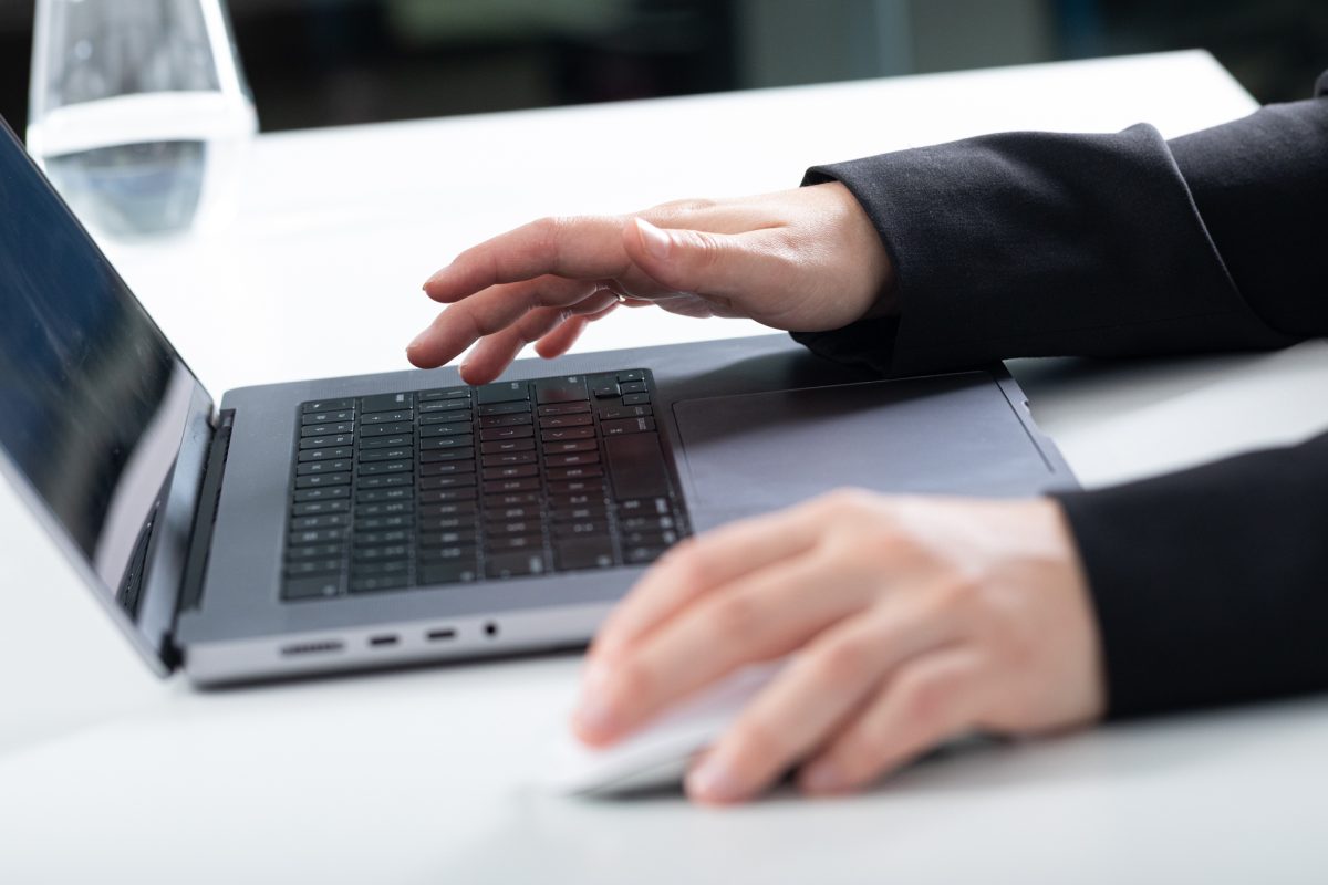 Hands using laptop computer