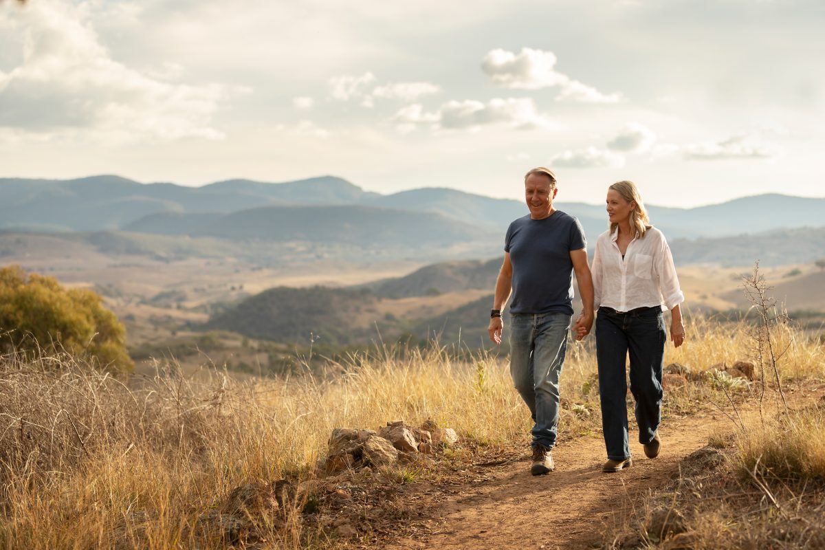 A couple walk along a picturesque ridge
