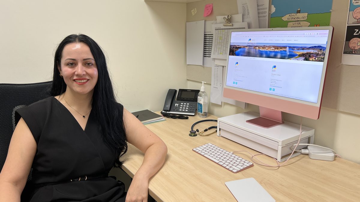Dr Amber Leah sits at a desktop computer