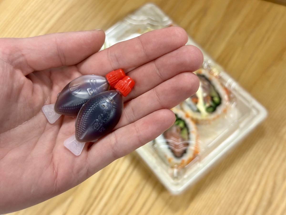 hand holding soy sauce fish