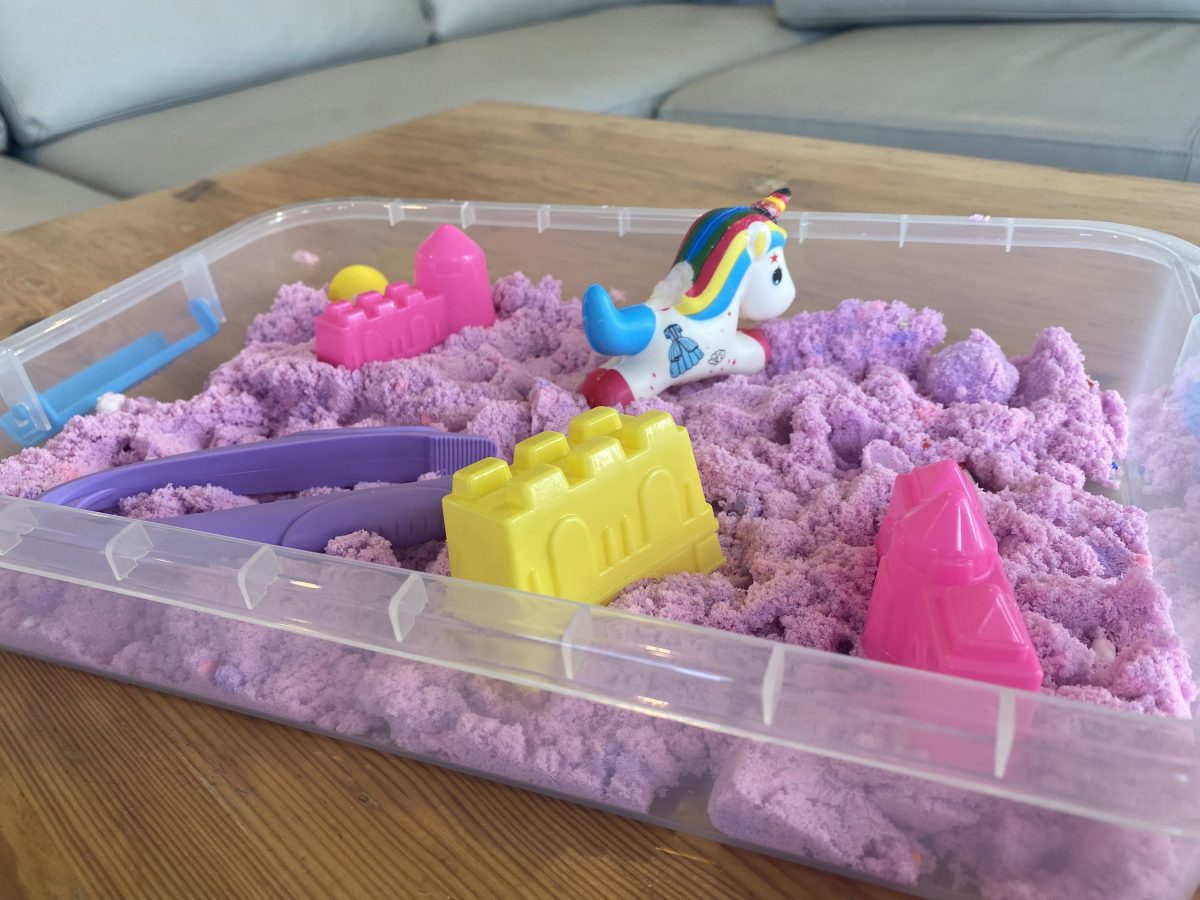 coloured play sand in a tray