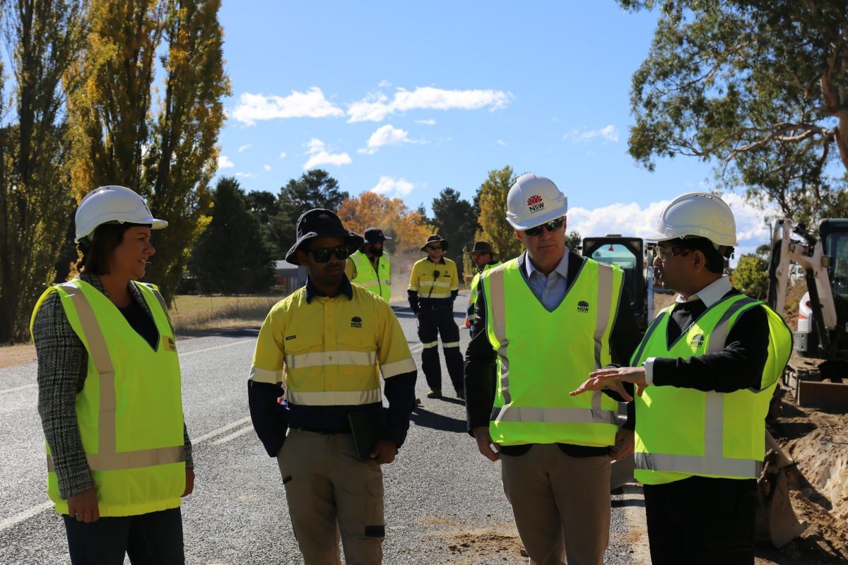 People standing in helmets and hi-vis vests