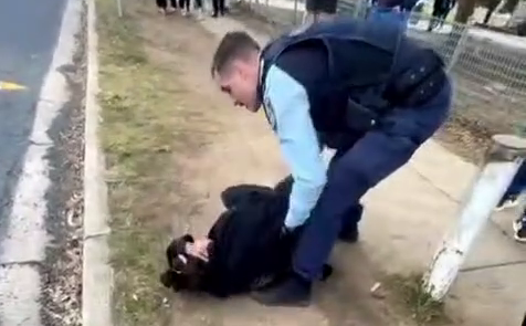 police officer next to woman on the ground